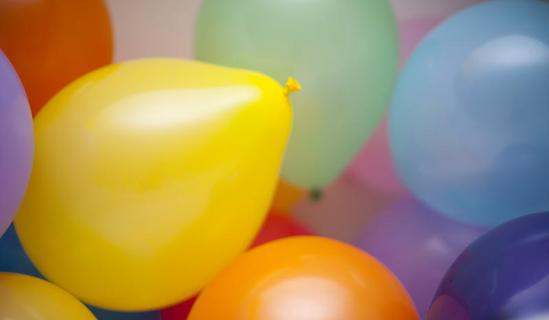 a background image of colorful balloons pictured with a stylish narrow depth of field to create an defuse focus effect.