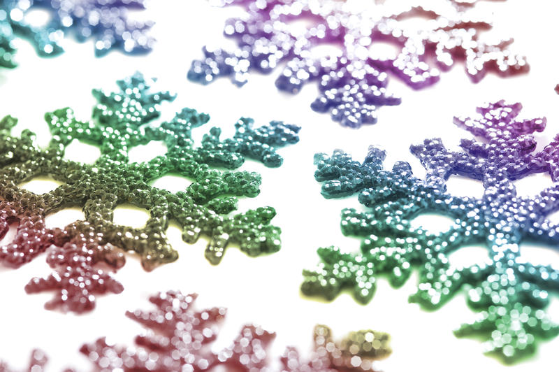 a background image of multi-colored snowflake shaped decorations