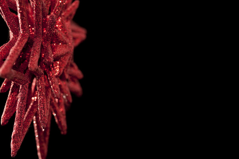 a red glitter covered christmas star shaped decoration