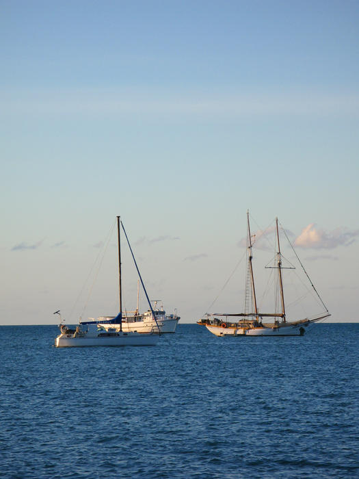 a schooner rigged boat and a modern bermuda rigged sloop yacht