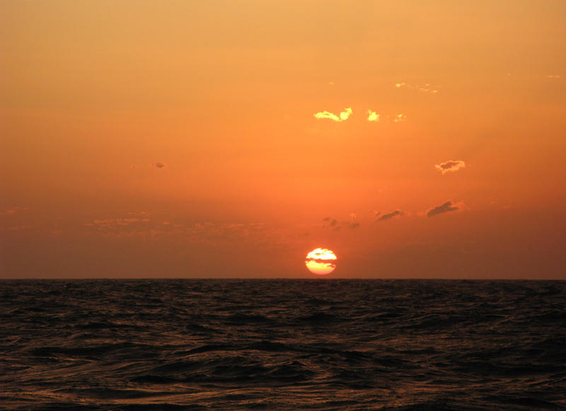 the sun setting over the water, queensland, australia