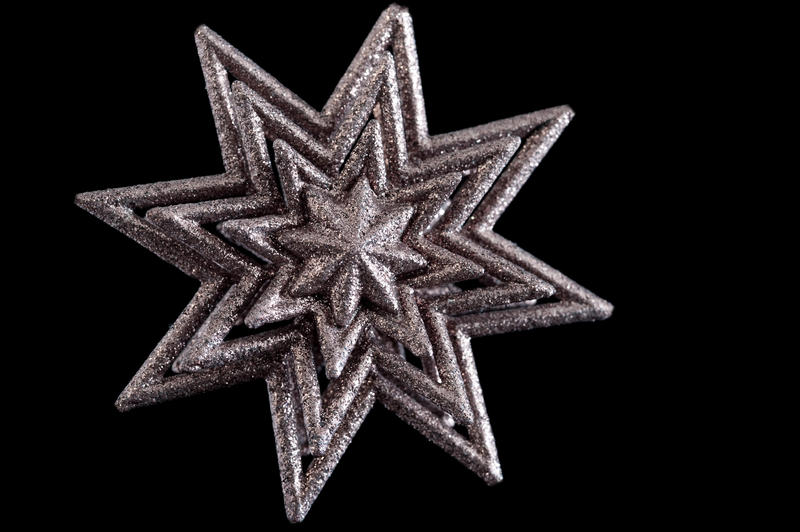 a pink glitter covered christmas star shaped decoration