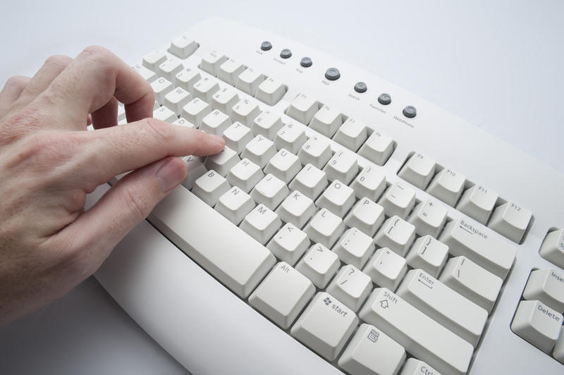 using a computer keyboard pecking at keys with a single finger, concept learning to type