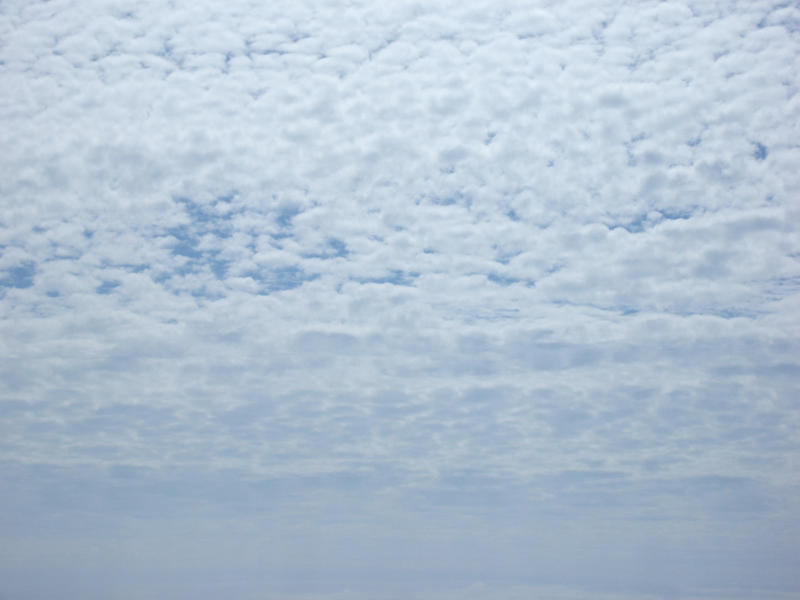 a background image featuring bright fluffy clouds in a hazy white sky