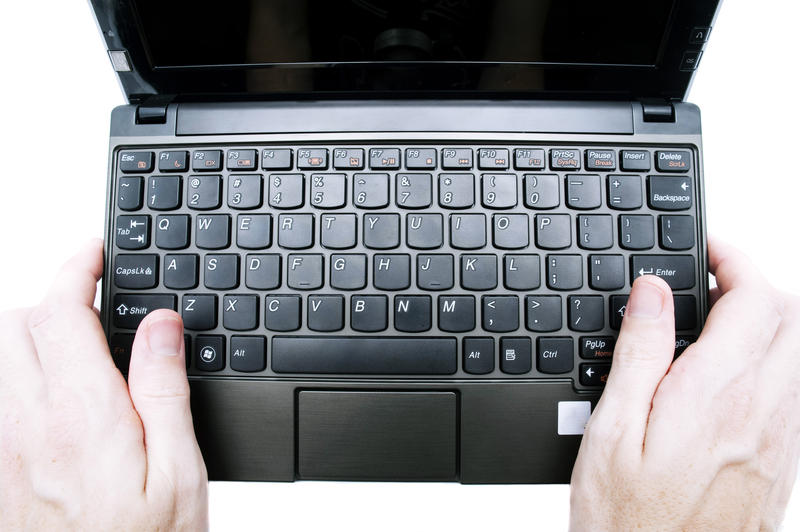 looking down and someone holding a small netbook computer