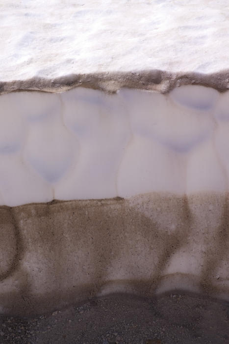 layers of melting snow in a spring thaw