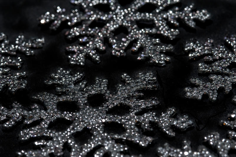 christmas snowflake shaped decorations on black