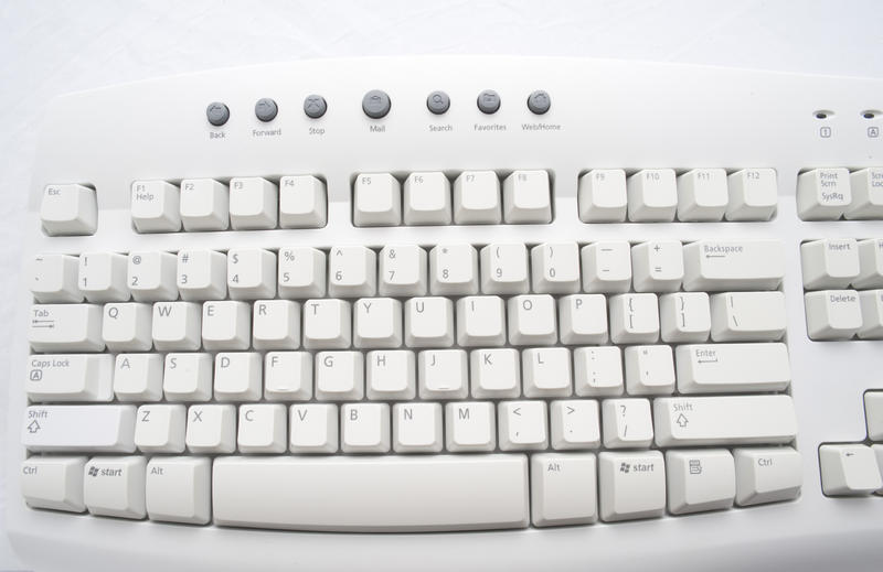 an old beige colored computer keyboard