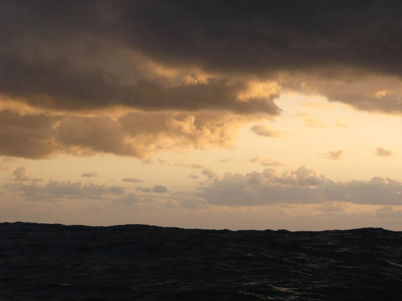 sunbeams streaming from behind a storm cloud