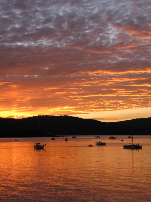 orange sunset sky relfection of the calm waters of a shelterd bay