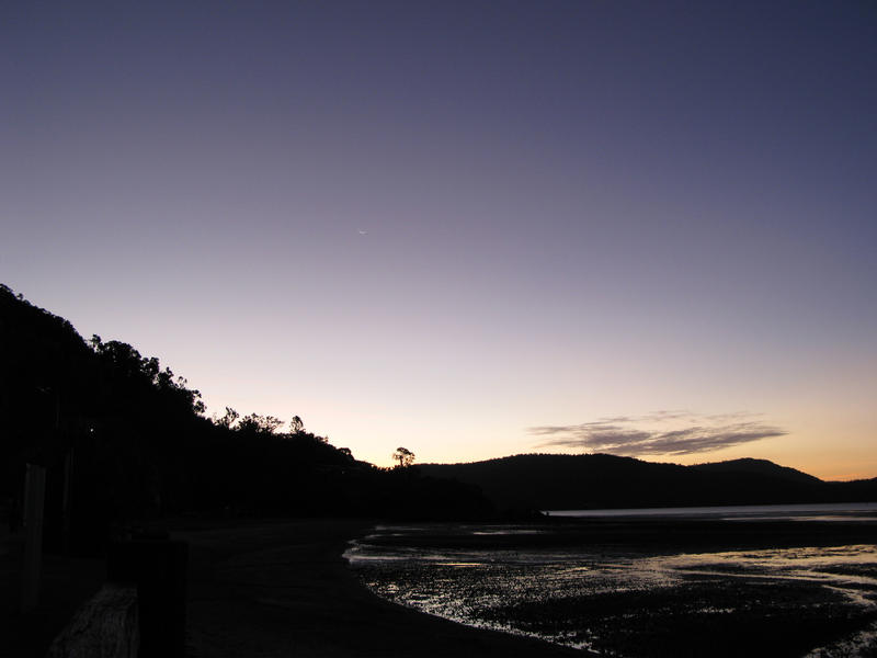 twilight after the sun has set leaving a silhouette of a coastal landscape