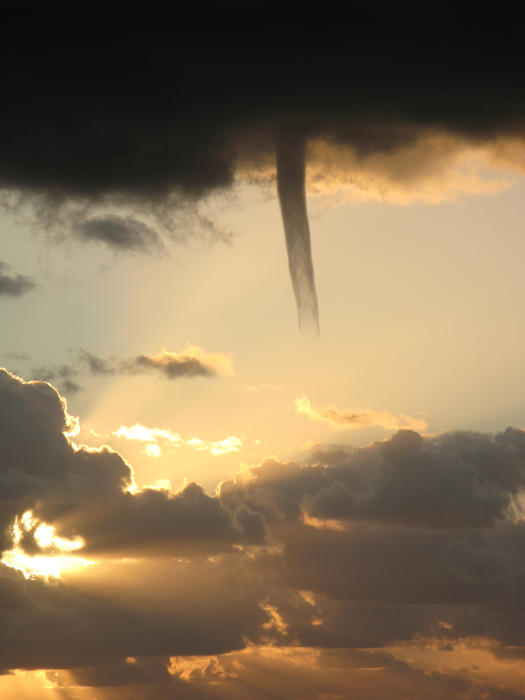 A cold air funnel cloud, like a mini tornado but is not in contact with the ground