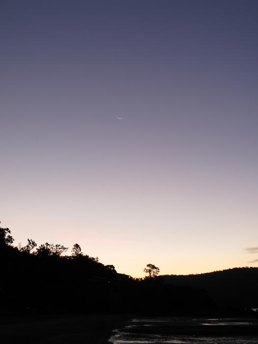 silhouette of a coastal landscape after sunset