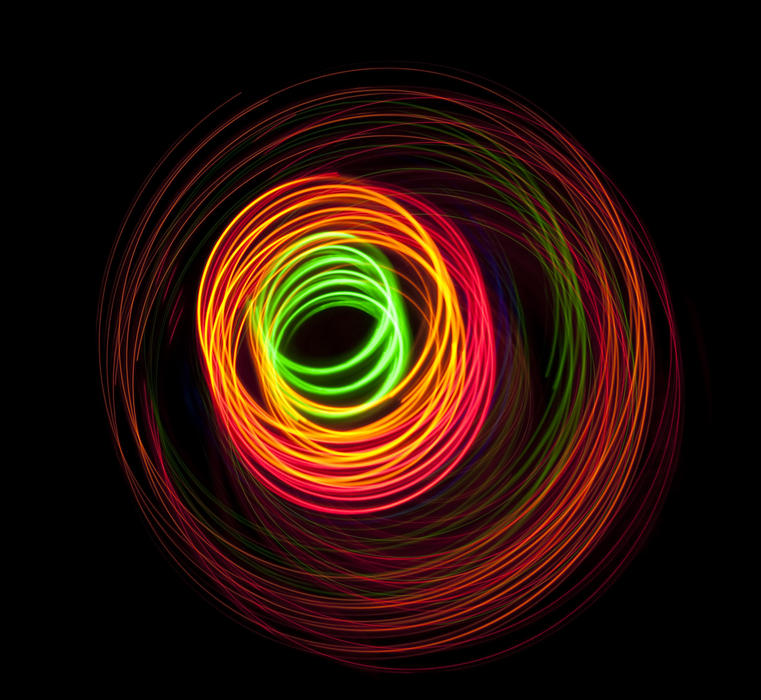 a colorful background of glowing spiral shapes in green orange and red