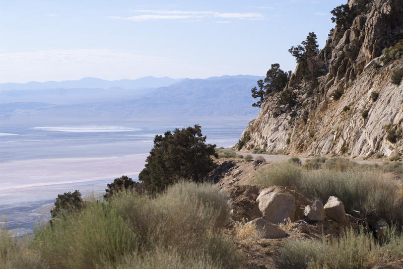 looking down from a roadside vista point across vast expanses of desert landscape