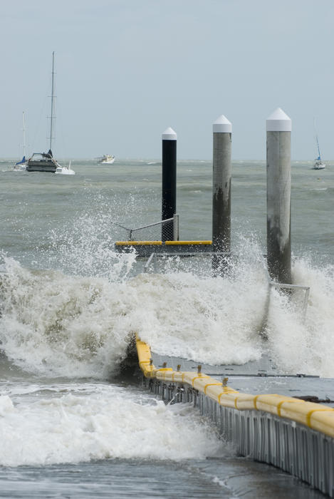 storm force winds and waves wrecking a floating pontoon jetty