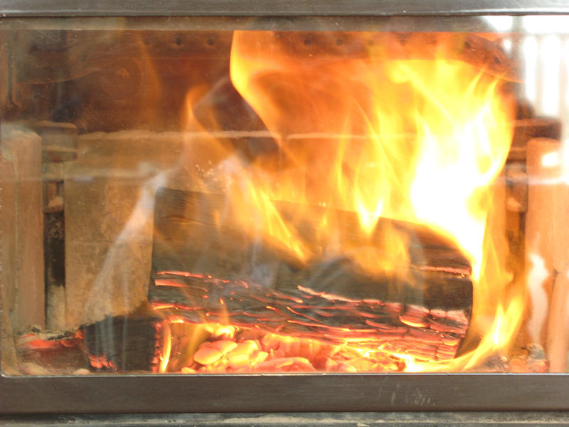 logs buring on a wood stove