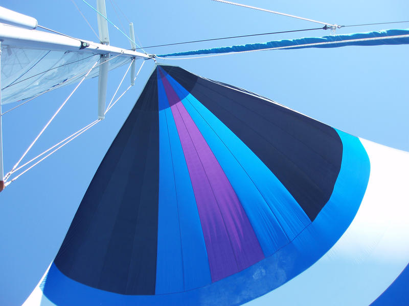 looking up at a yacht with its spinnaker hoisted