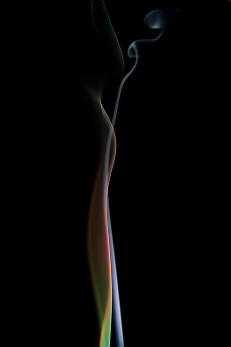 trails of rising smoke shot with colored lights