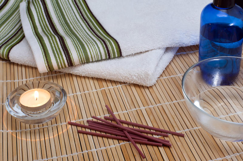 scented massage oil and incense sticks for an indulgent aromatherapy massage
