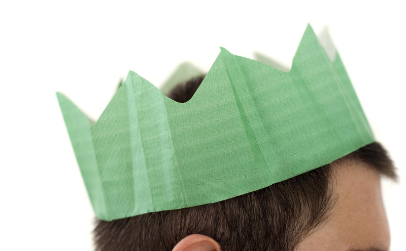 a man wearing a green paper christmas party hat