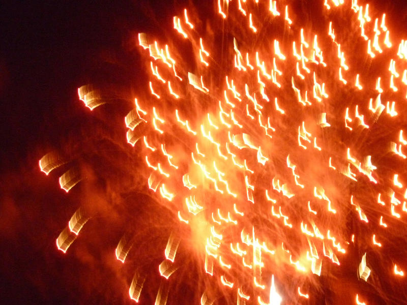 an explosion of red light during a firework display