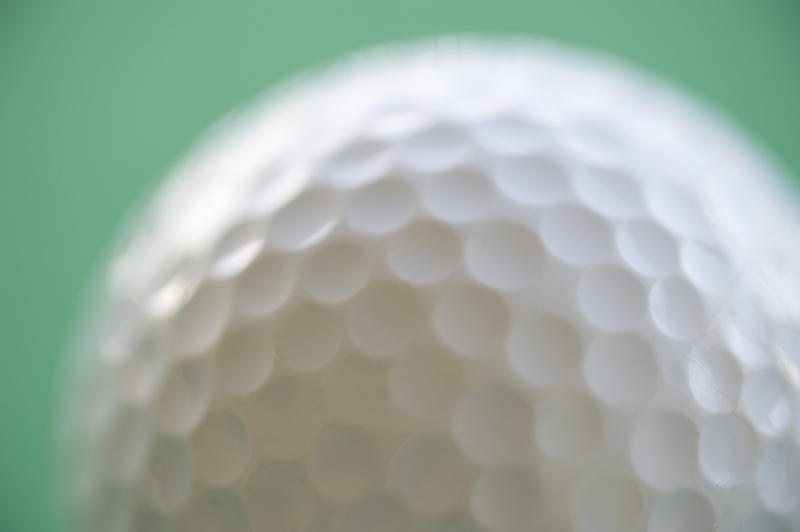 macro image of the dimples of a golf ball