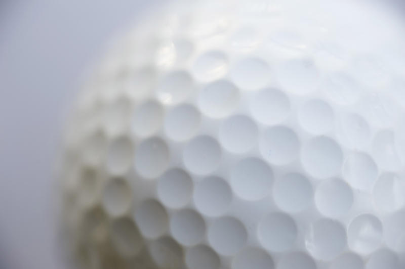 details of the dimpled surface of a golf ball