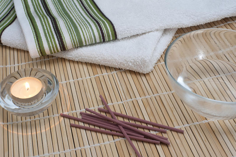 massage oil and scented candle for an aromatic massage