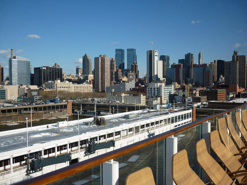 a view of the new york skyline from the deck of a cruise ship