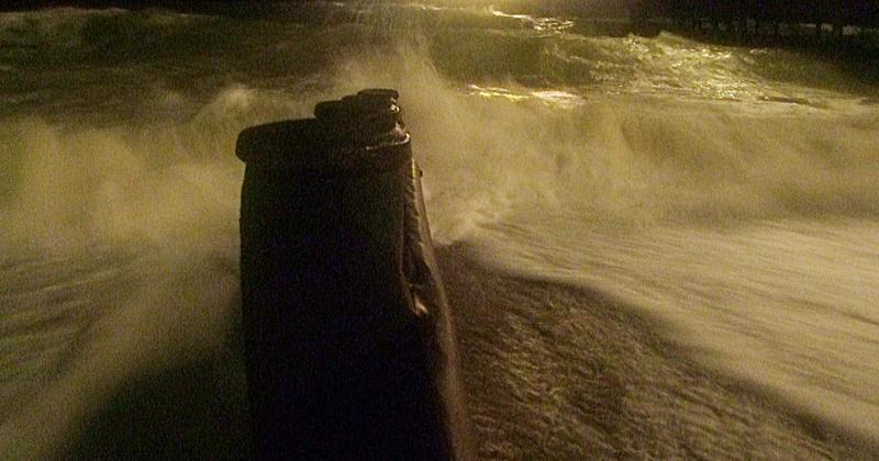 <p>abstract - grainy image of stormy waves hitting a rock</p>