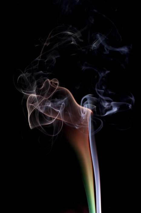 an attractive colorful cloud of smoke trails on a black backdrop