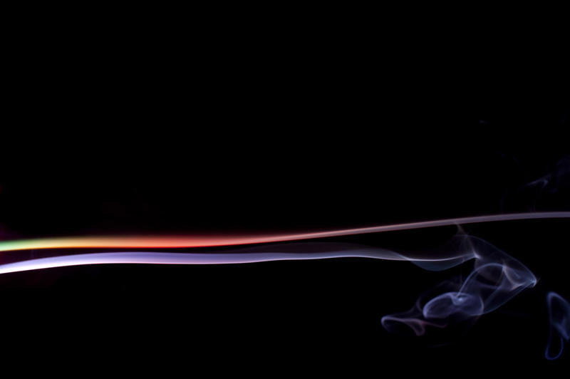 a colorful illuminated trail of smoke vapour