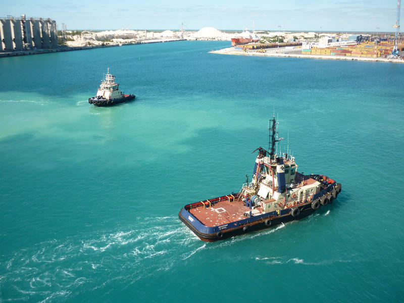 tug boats at a busy shipping terminal