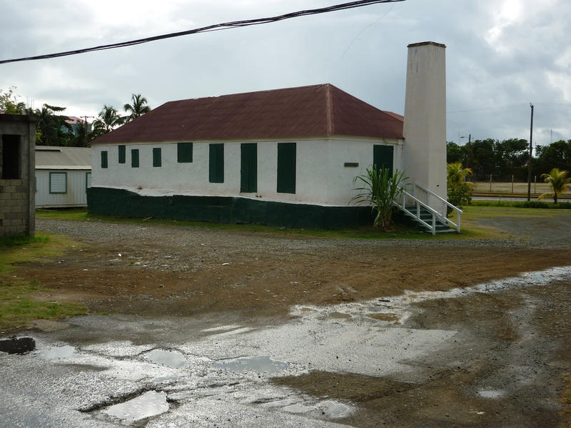 an old building with closed window and door shutters