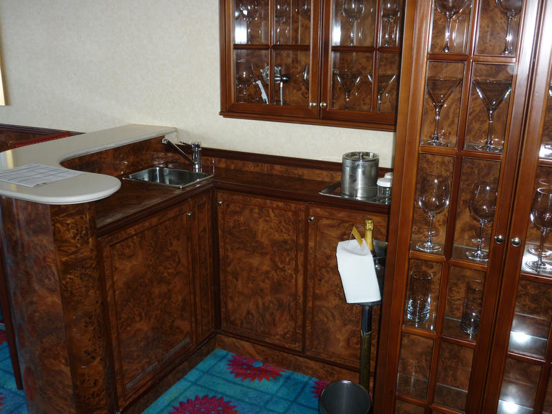 walnut bar counter and glass cabinets