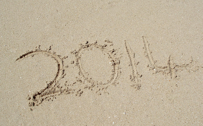 written in sand on a beach the year 2014