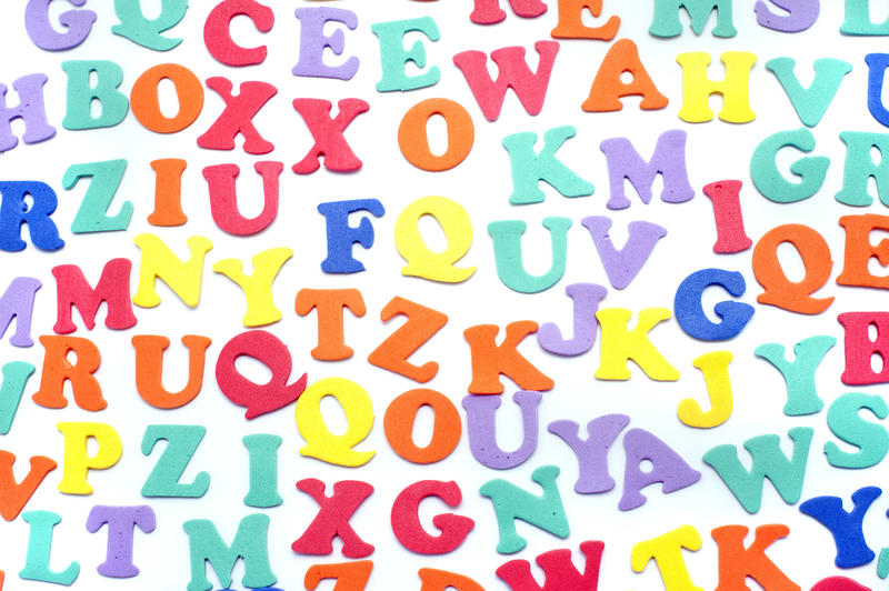 Array of colourful alphabet letters in uppercase on a white background for teaching children languages