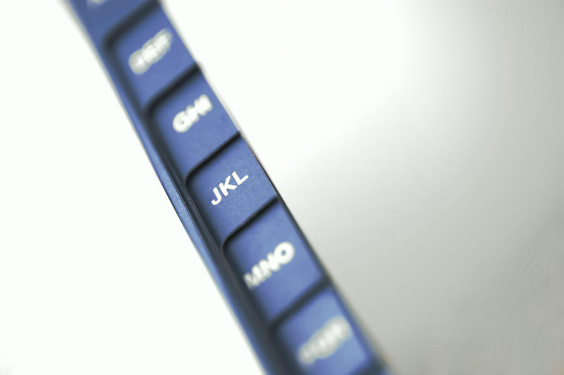 Closeup view with selective focus of a set of alphabetical tab dividers on a book or folder