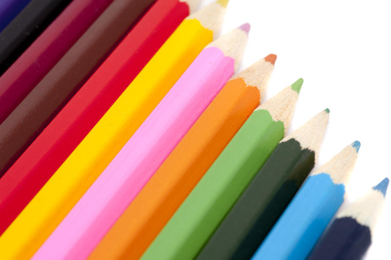 Closeup of a neat row of colouring pencils in a range of bright colours