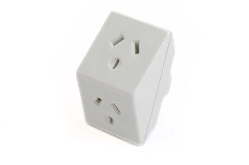 a white plastic australian dual adaptor plug