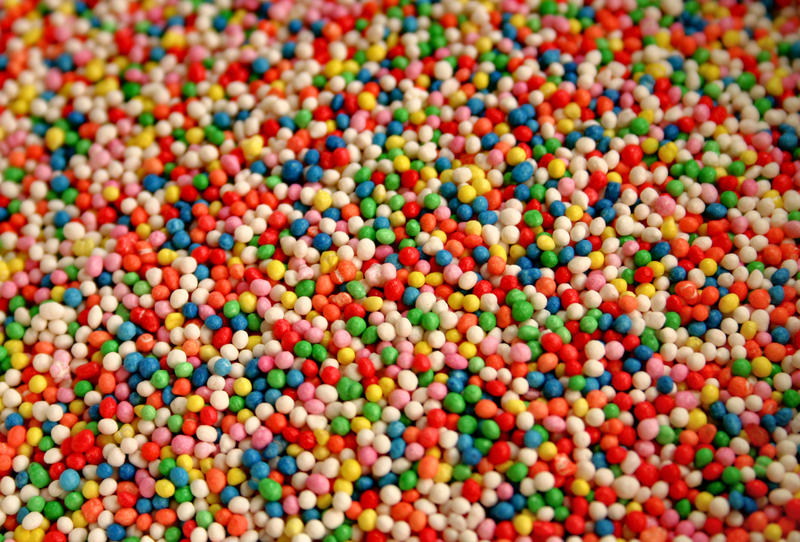 <p>close up of bulk quantity of colourful sugary 100s and 1000s sprinkles&nbsp;</p>