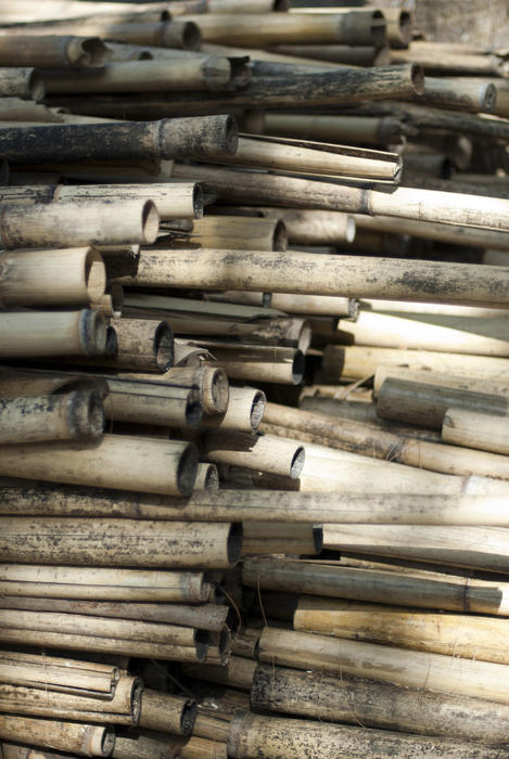 Closeup background of cut and dried bamboo pieces for use in the manufacture of furniture or in construction