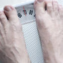 6888   Man standing barefoot on a bathroom scale
