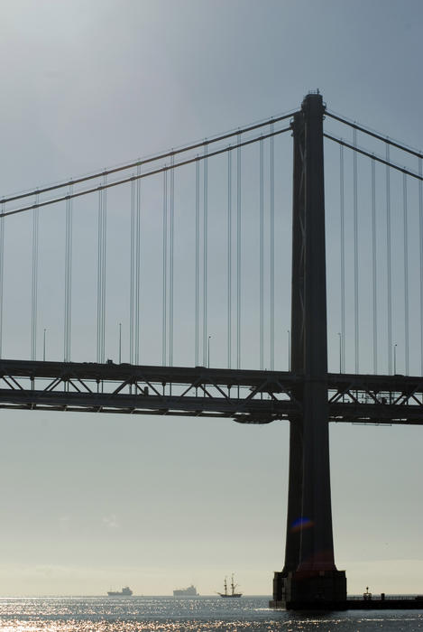 The san francisco bay bridge tower in silhouette
