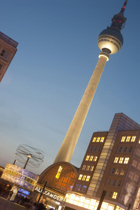 Nighttime view of the Alexanderplatz, Berlin, showing the illuminated World Clock and the TV tower, or Fernsehturm, tilted angle view