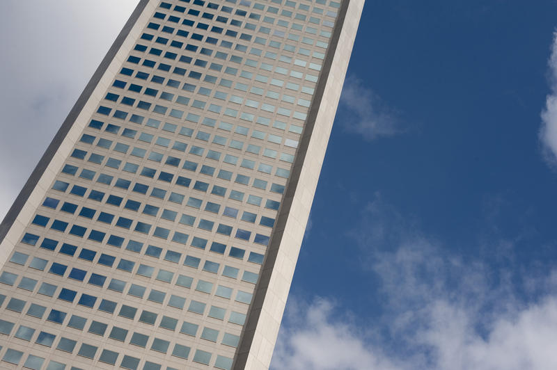 External facade of a corporate or big business office block with multiple windows reaching for the sky