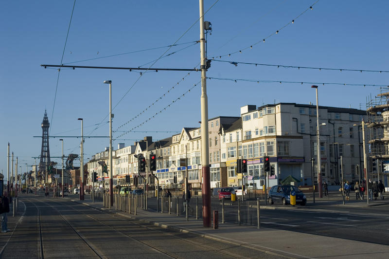 Blackpool, Lancashire, England street scene looking down past commercial and residential buildings to the historic Blackpool Tower