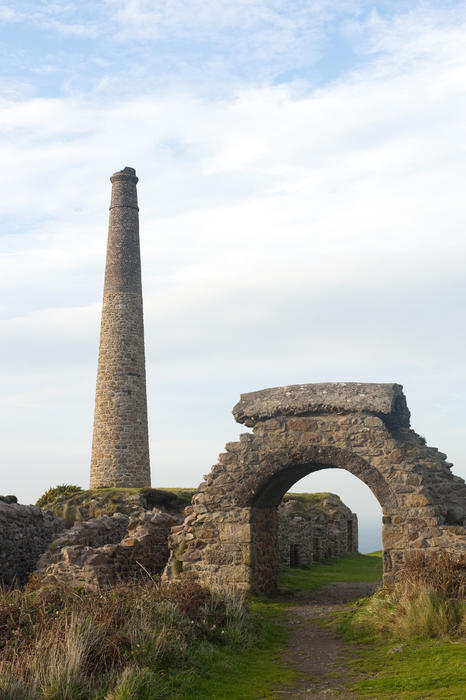 Ruined arch and chimney, Botallack mine, Cornwall, an abandoned tin mine in the Cornwall and West Devon Mining Landscape World Heritage site