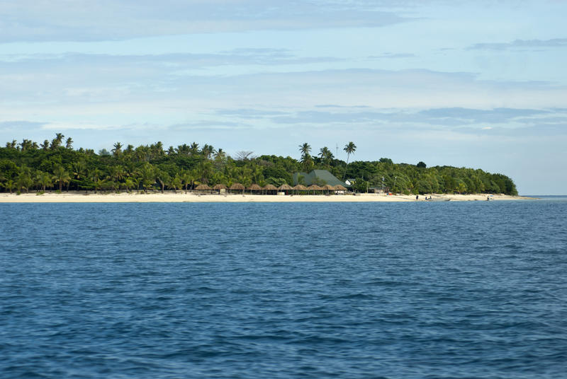 View from the ocean of a beach resort on the golden beach of low lying Bounty Island in Fiji